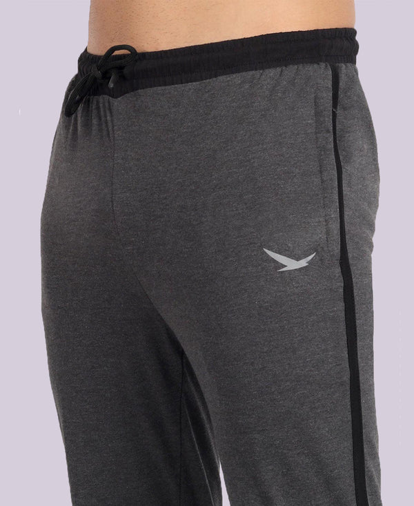 Gray sweatpants with a black drawstring and side stripe on a light gray background